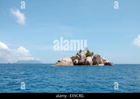 A small rocky island with palm trees near the Mahe island, Indian Ocean, Seychelles Stock Photo