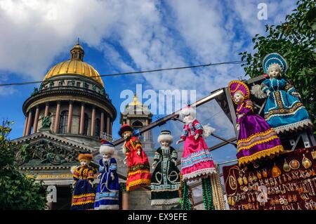 Souvenir market stall selling Russian dolls in front of St Isaac's Cathedral. St Petersburg. Russia Stock Photo