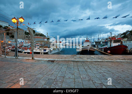 View of the boats in port of Hydra and Peloponnese in the distance Stock Photo