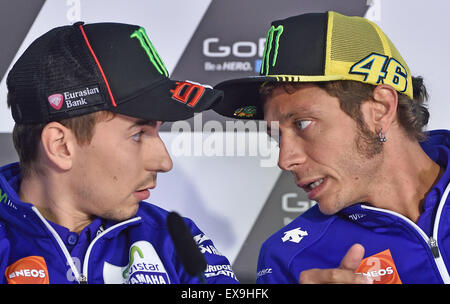 Hohenstein-Ernstthal, Germany. 09th July, 2015. Italian MotoGP rider Valentino Rossi (R) of the Movistar Yamaha MotoGP team and his Spanish teammate Jorge Lorenzo (L) attend a press conference at the Sachsenring circuit in Hohenstein-Ernstthal, Germany, 09 July 2015. The Motorcycling Grand Prix of Germany will take place on 12 July 2015. Photo: HENDRIK SCHMIDT/dpa/Alamy Live News Stock Photo