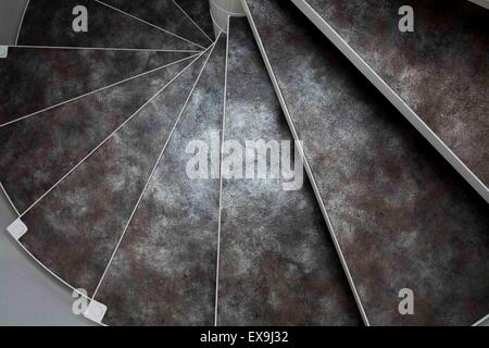 Spiral staircase with texture and natural black and white feel. Marble / stone design. Stock Photo