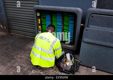 BT Openreach engineer working on a junction box in Bristol city, England, UK