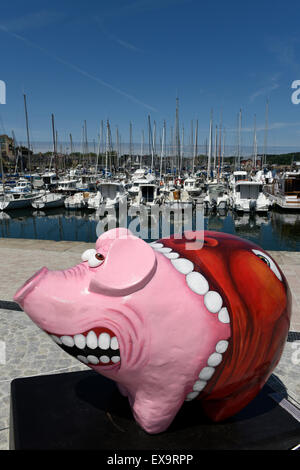 Pig Parade at Paimpol Harbour, Paimpol, Côtes-d'Armor, Brittany, France.  15 decorated pig sculptures by different artists. Stock Photo