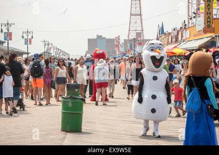 Costumed characters solicit tips on the boardwalk on a seasonably warm Sunday, July 5, 2015 in Coney Island in Brooklyn in New York over the 4th of July weekend. Some of the characters have moved from Times Square to Coney Island because of the increased competition.  (© Richard B. Levine) Stock Photo