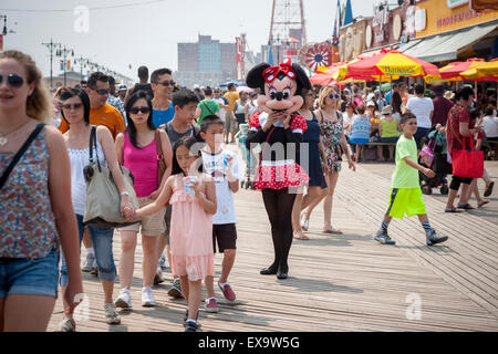 Costumed characters solicit tips on the boardwalk on a seasonably warm Sunday, July 5, 2015 in Coney Island in Brooklyn in New York over the 4th of July weekend. Some of the characters have moved from Times Square to Coney Island because of the increased competition.  (© Richard B. Levine) Stock Photo
