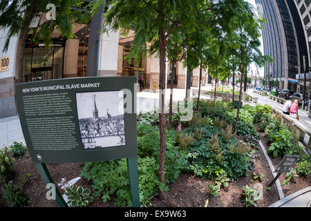 A plaque on Wall Street in New York commemorates the slave market that took place there from 1711 until 1762 when New York was New Amsterdam, seen on Friday, July 3, 2015.  (© Richard B. Levine) Stock Photo