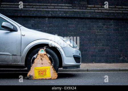 Car clamped for being an untaxed vehicle Stock Photo