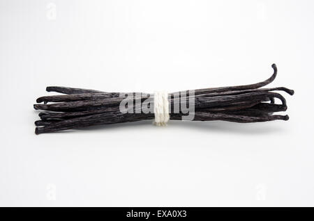 A group of vanilla beans wrapped in twine isolated on white Stock Photo