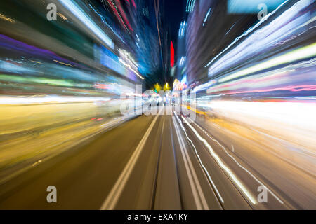 China, Hong Kong, Blurred image of neon street signs from Hong Kong Tramways street car traveling through city center on winter Stock Photo