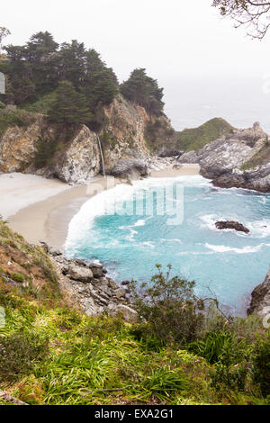 Waterfall in Julia Pfeifer Burns State Park, on a cloudy day, with turquoise water Stock Photo