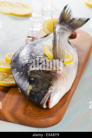 Wooden Cutting Board full of Fish Scales and Fish Fillet Preparations  cutting head of fish with Traditional Indigenous Same Knife after fishing  trip Stock Photo - Alamy