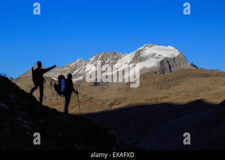 Hikers admire the view of Alpi Graie (Graian Alps) landscape, Gran Paradiso National Park, Italy, Europe Stock Photo