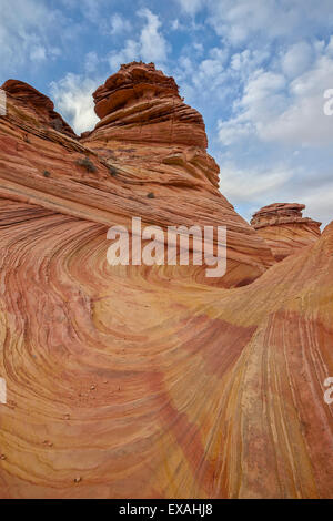 Sandstone wave and cones under clouds, Coyote Buttes Wilderness, Vermilion Cliffs National Monument, Arizona, USA Stock Photo