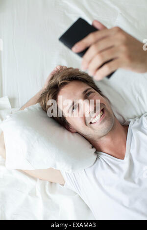 Man video conferencing on smartphone Stock Photo