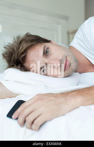 Man relaxing on bed Stock Photo