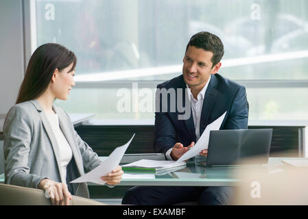 Business associates reviewing document Stock Photo