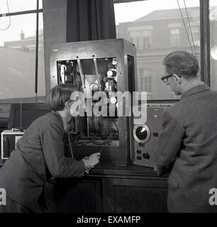 1950s, historical, young male student learning to become an electronical engineer with teacher, working on a transmitter. Stock Photo