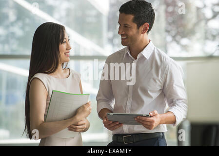 Office mates chatting Stock Photo