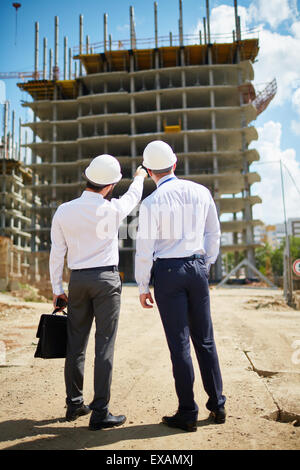 Two architects standing in front of new construction Stock Photo