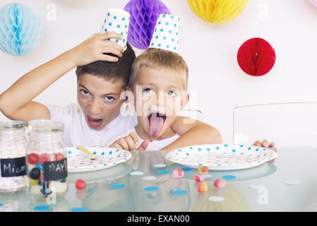 Young brothers making faces during a birthday party