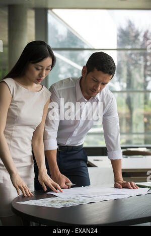 Engineer and associate working closely together on project Stock Photo