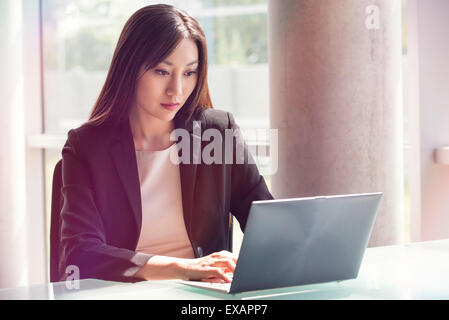 Woman using laptop computer Stock Photo