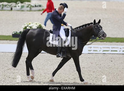 German dressage rider Matthias Alexander Rath takes off his hat after his ride on his horse Totilas in Hagen am Teutoburger Wald, Germany, 10 July 2015. Rath started in the Grand Prix de Dressage in order to qualify for the Dressage European Championships. PHOTO: FRISO GENTSCH/DPA Stock Photo