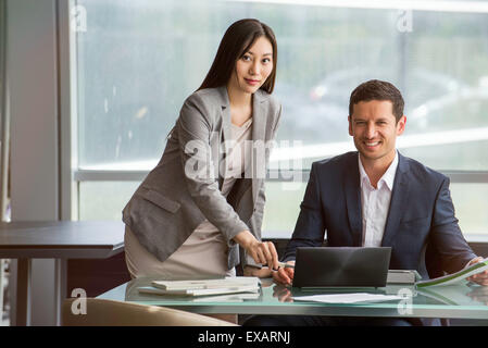 Business professionals collaborating closely on project Stock Photo