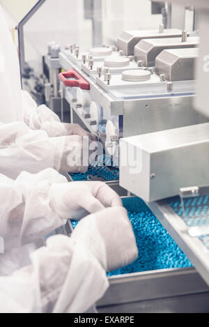 Worker monitoring pill packaging machinery Stock Photo