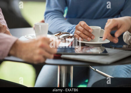 Friends having coffee in cafe, cropped Stock Photo