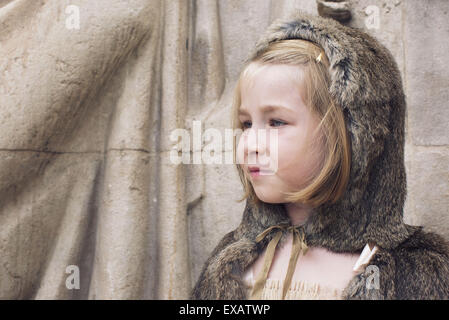 Little girl wearing hooded fur cloak outdoors, portrait Stock Photo