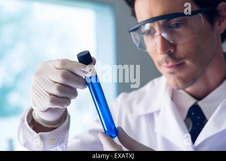 Scientist examining test tube Stock Photo