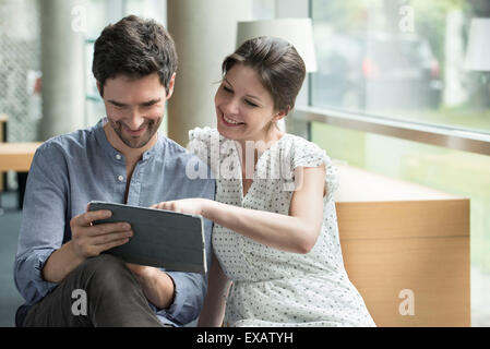 Couple using digital tablet together at home Stock Photo