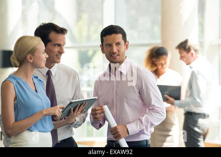 Professionals collaborating using digital tablet Stock Photo