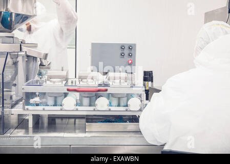 Technicians at work in prescription drug production facility Stock Photo