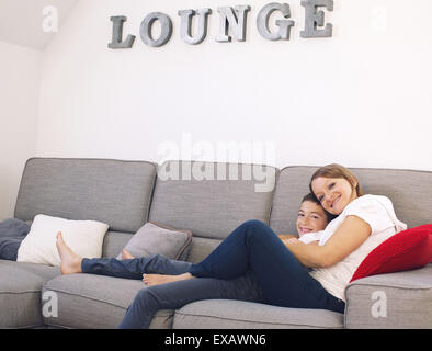 Mother and son relaxing together on sofa Stock Photo