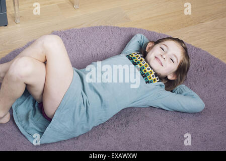 Girl Lying On Floor With Hands Behind Head Smiling Stock Photo Alamy