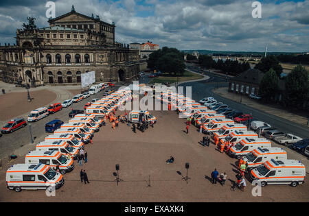 Dresden, Germany. 10th July, 2015. 32 brand new rescue vehicle or on display in front of the Semperoper opera house in Dresden, Germany, 10 July 2015. Saxony's Interior Minister Markus Ulbig (CDU) handed the vehicles to various rescue organisation in the state of Saxony during a ceremonial act. Photo: Oliver Killig/dpa/Alamy Live News Stock Photo