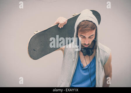 young hipster gay man with skate in the city Stock Photo