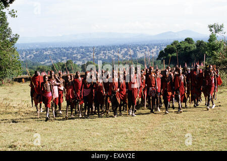 Lolgorian, Kenya. Siria Maasai Manyatta; a group of young moran, red ochre coloured short hair, shell and bead decorations. Stock Photo