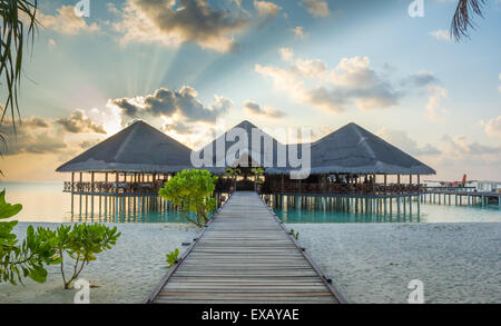 Jetty leading to overwater resort hotel restaurant and arrival Stock Photo