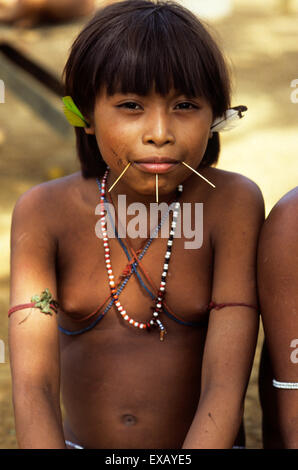 Roraima, Brazil. Smiling Yanomami girl with bead necklace, sticks in pierced cheeks. Stock Photo