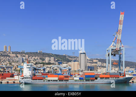 Panoramic View of the city of Haifa from Haifa's Port dock with container ship and Carmel mountain in the background Stock Photo