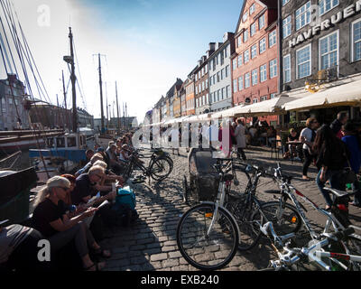 tourists enjoy the waterfront at Nyhavn harbour area,Copenhagen,Denmark Stock Photo