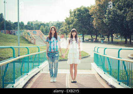 beautiful hipster young women sisters friends in the city Stock Photo ...