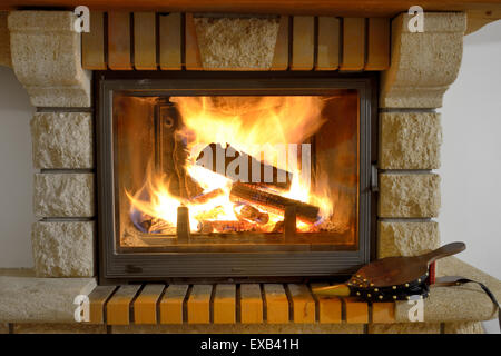 crest of flame on burning wood in fireplace Stock Photo