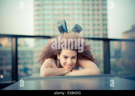 young beautiful long curly hair hipster woman in the city Stock Photo