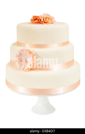 Simple three tiered wedding cake with flower decorations on a cake stand. Cut out and isolated on a white background Stock Photo