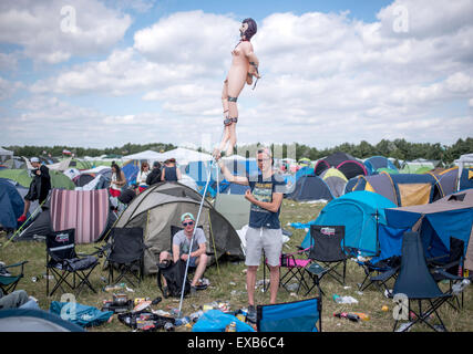 Ferropolis, Germany. 10th July, 2015. Justin holds an inflatable doll on a pole at the Splash Festival in Ferropolis, Germany, 10 July 2015. The Splash Festival is sold out with 20'000 visitors and runs from 10-12 July 2015. PHOTO: OLE SPATA/DPA/Alamy Live News Stock Photo