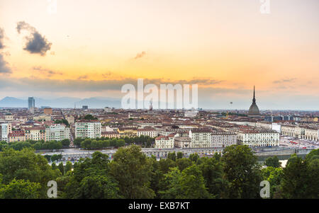 Sunset on Torino (Turin), Piedmont, Italy. Panoramic cityscape from above with Mole Antonelliana towering on the city and romati Stock Photo